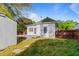 Backyard view showing a wooden deck with a small storage building along with a grassy area at 302 N Sumner St, Selma, NC 27576