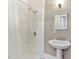 Bathroom includes a shower-tub combo with shower curtain and a pedestal sink with a mirror and vanity lighting at 302 N Sumner St, Selma, NC 27576