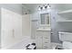 Bathroom features a shower-tub combo, a modern vanity, a mirror, toilet and black and white tiled floor at 302 N Sumner St, Selma, NC 27576
