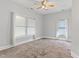 Spacious bedroom with neutral carpet, large windows with blinds, and neutral paint throughout at 302 N Sumner St, Selma, NC 27576