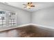 Bedroom featuring hardwood floors, a window, ceiling fan, and white trim at 302 N Sumner St, Selma, NC 27576