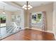 Dining room with hardwood floors, chandelier, and direct access to the kitchen and patio at 302 N Sumner St, Selma, NC 27576
