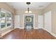 Dining room featuring hardwood floors, a chandelier, and access to other rooms at 302 N Sumner St, Selma, NC 27576