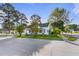Charming home exterior showcasing its architectural style, surrounding trees, and well-maintained landscape at 302 N Sumner St, Selma, NC 27576