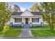Inviting home exterior featuring a classic front porch with detailed columns and well-manicured landscaping at 302 N Sumner St, Selma, NC 27576