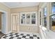 Sunroom with checkered tile, lots of natural light, and access to the outside at 302 N Sumner St, Selma, NC 27576