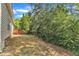 Spacious backyard featuring mature trees, landscaping, and a view of the home at 308 Ravenstone Dr, Cary, NC 27518