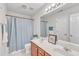 Bathroom with double sinks, wood vanity, and full size mirror at 308 Ravenstone Dr, Cary, NC 27518
