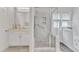 Bright and modern bathroom with glass enclosed shower and white vanity at 308 Ravenstone Dr, Cary, NC 27518