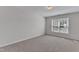 This bedroom is bright, featuring neutral carpet and a large window that lets in natural light at 308 Ravenstone Dr, Cary, NC 27518