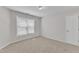 This bedroom is bright, featuring neutral carpet and a large window that lets in natural light at 308 Ravenstone Dr, Cary, NC 27518