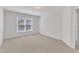 This bedroom is bright, featuring neutral carpet and a large window that lets in natural light at 308 Ravenstone Dr, Cary, NC 27518