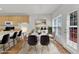 Staged dining room with stylish chairs and view of open kitchen at 308 Ravenstone Dr, Cary, NC 27518