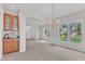 Bright dining room featuring a chandelier, a built-in cabinet, and large windows at 308 Ravenstone Dr, Cary, NC 27518