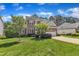 Two-story brick home boasts manicured lawn, attached garage, and mature landscaping at 308 Ravenstone Dr, Cary, NC 27518