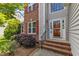 Inviting front entrance with red brick steps and colorful glass front door at 308 Ravenstone Dr, Cary, NC 27518