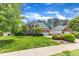 Charming brick and vinyl home and landscaped front yard with driveway at 308 Ravenstone Dr, Cary, NC 27518