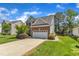 Two-story brick home boasts an attached two car garage and driveway at 308 Ravenstone Dr, Cary, NC 27518