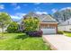 Beautifully landscaped front yard with brick and vinyl home and attached garage at 308 Ravenstone Dr, Cary, NC 27518