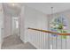 Well-lit hallway featuring an arched window and an open staircase, enhancing the home's architectural appeal at 308 Ravenstone Dr, Cary, NC 27518