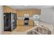 Well-lit kitchen features modern appliances, light wood cabinets, and stone countertops at 308 Ravenstone Dr, Cary, NC 27518