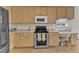 Well-lit kitchen with stainless steel appliances, desk space, and ample storage at 308 Ravenstone Dr, Cary, NC 27518