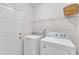 Bright laundry room featuring a side-by-side washer and dryer, equipped for convenient laundry tasks at 308 Ravenstone Dr, Cary, NC 27518