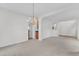Living room featuring carpet, a chandelier, and an arched doorway at 308 Ravenstone Dr, Cary, NC 27518