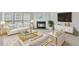 Bright, staged living room with modern furniture, fireplace, and natural light at 308 Ravenstone Dr, Cary, NC 27518