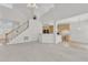 Bright open-concept living room features a fireplace and stairs to second level at 308 Ravenstone Dr, Cary, NC 27518