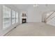 Bright living room with a fireplace, neutral color scheme, and large windows at 308 Ravenstone Dr, Cary, NC 27518