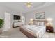 Staged main bedroom suite with luxury bedding, white walls, and lots of space at 308 Ravenstone Dr, Cary, NC 27518
