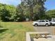 Large backyard with a shed, parking space, and plenty of green space and mature trees at 309 19Th St, Butner, NC 27509