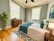Bedroom featuring hardwood floors, neutral walls, a ceiling fan, and ample natural light from two windows at 309 19Th St, Butner, NC 27509