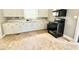 Functional kitchen with black appliances, white cabinets, and lots of counter space at 309 19Th St, Butner, NC 27509