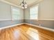 Bright room with hardwood floors, large windows, ceiling fan and neutral tones at 309 19Th St, Butner, NC 27509