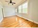 Spacious living area with beautiful hardwood floors, lots of natural light, and a ceiling fan at 309 19Th St, Butner, NC 27509