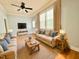 Bright living room with two sofas, ceiling fan, natural light, and hardwood floors at 309 19Th St, Butner, NC 27509