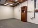 Unfinished basement area featuring carpet, exposed utilities and built-in bar and wine storage at 315 King George Loop, Cary, NC 27511