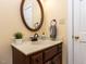 Traditional-style bathroom featuring a wood vanity and decorative mirror at 315 King George Loop, Cary, NC 27511