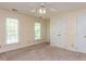 Neutral bedroom with carpet floors, windows, and closet doors at 315 King George Loop, Cary, NC 27511