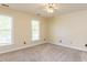 This bright bedroom features two large windows, neutral walls, and carpeting at 315 King George Loop, Cary, NC 27511