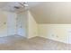 This bonus room features angled ceilings with neutral walls and carpeting at 315 King George Loop, Cary, NC 27511
