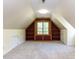 This bonus room features an A-frame window with built in shelves and storage at 315 King George Loop, Cary, NC 27511