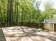 Large wooden deck with railing surrounded by mature trees and lush greenery providing privacy at 315 King George Loop, Cary, NC 27511