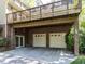 Rear exterior with two-car garage, second story deck and brick foundation at 315 King George Loop, Cary, NC 27511