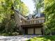 Rear view of home featuring two-car garage, second story deck and neutral exterior at 315 King George Loop, Cary, NC 27511