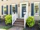 Home's entrance featuring a brick pathway and well-maintained landscaping at 315 King George Loop, Cary, NC 27511