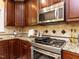 Close-up view of a kitchen with a stainless steel range and granite countertops at 315 King George Loop, Cary, NC 27511