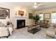 Cozy living room boasts a fireplace, neutral tones, and an inviting sitting area at 315 King George Loop, Cary, NC 27511